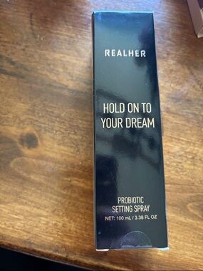 RealHer Probiotic Setting Spray in Black with Gold Lettering